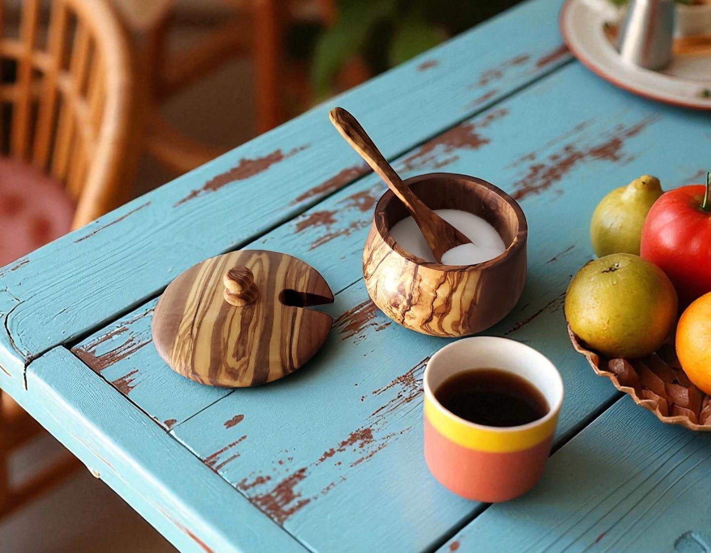 OLIVIKO Olive Wood sugar bowl with lid and spoon on rustic blue table with coffee cup and fruit bowl