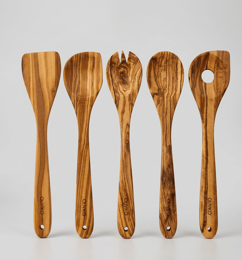 Five olive wood utensils - a spatula and four spoons - lined up on a light gray background, each branded with OLIVIKO logo