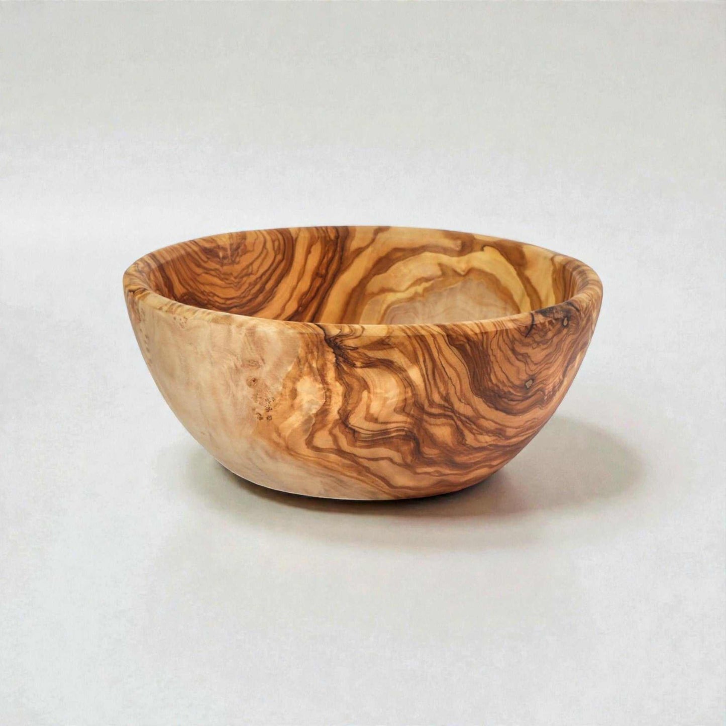 Handcrafted OLIVIKO Olive Wood Bowl with natural grain patterns, perfect for serving salads and snacks