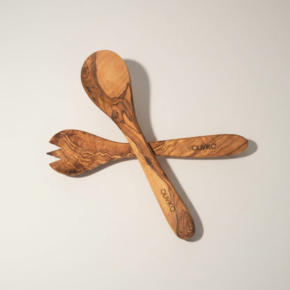 Handmade olive wood salad fork and spoon servers – side view on neutral background