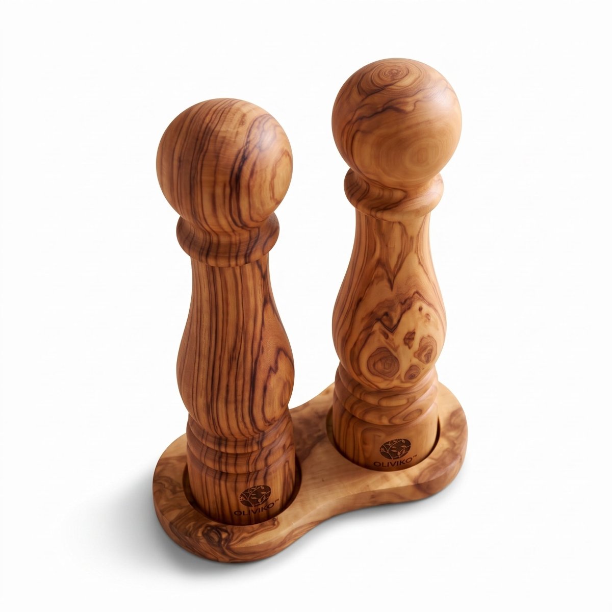 Two carved olive wood salt and pepper mills on a matching wooden base, photographed on a clean white background.