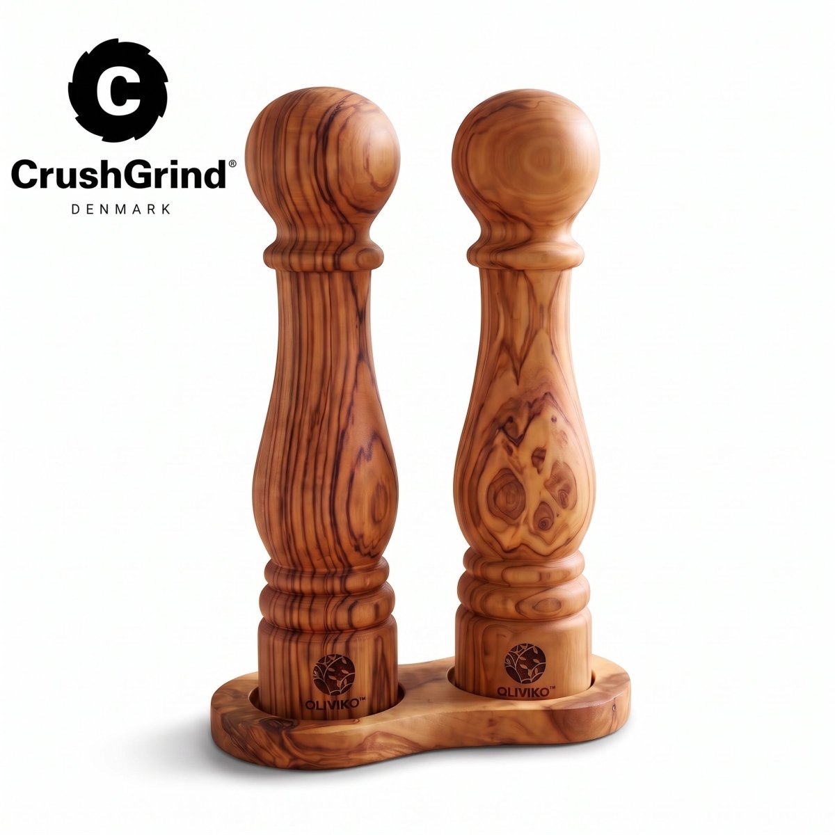 Two wooden pepper and salt mills with a rich grain pattern, standing in a matching wooden base on a white background. The CrushGrind logo is visible in the top left corner.